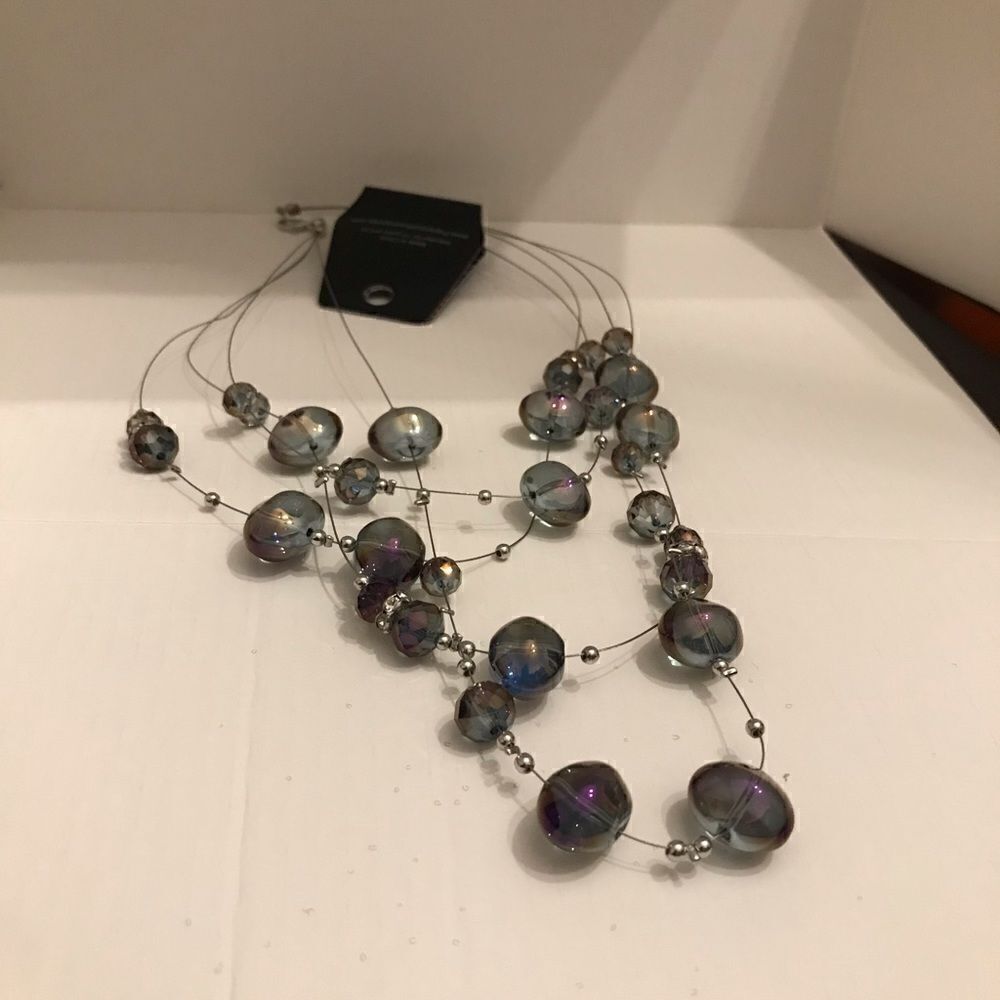 This is a gunmetal beaded necklace with rhinestones separators.